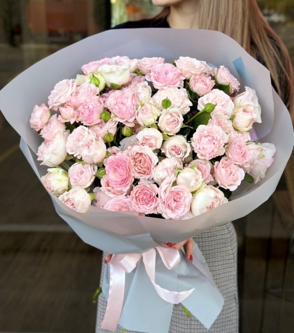 A charming bouquet titled "Pastel Paradise," featuring delicate spray roses in soft shades of pink and cream, elegantly arranged and gently wrapped.