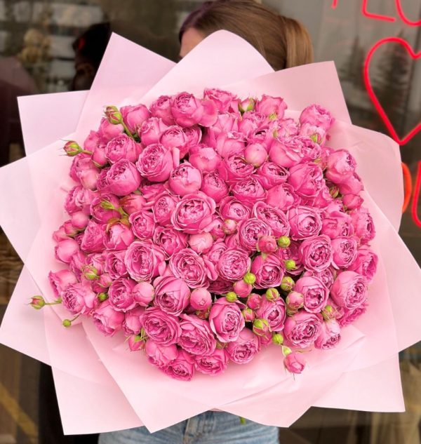 A stunning bouquet titled "Pink Blossom Bliss," featuring lush peony roses in bright pink shades, elegantly arranged and wrapped in soft pink packaging.