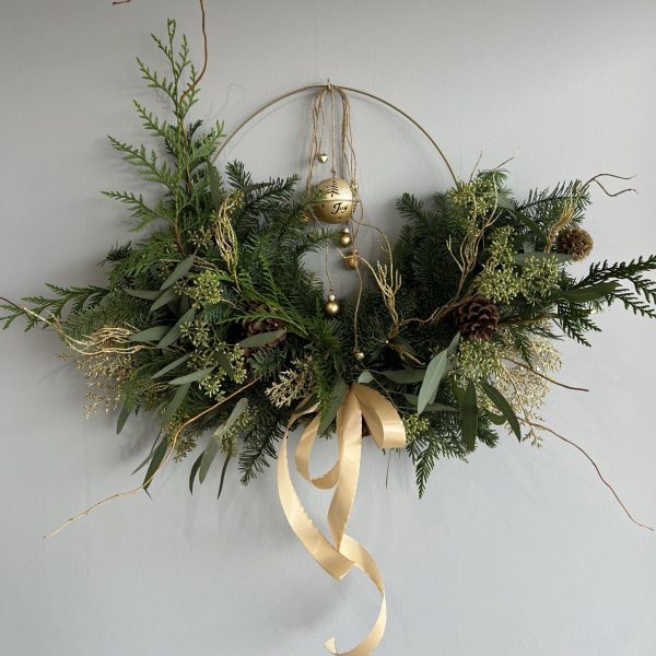 Christmas arrangement "Evergreen Magic" featuring a mini Christmas tree adorned with gold ornaments, creating a festive and elegant holiday display.