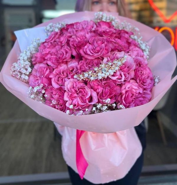 Floral arrangement "Purple Reverie" featuring deep purple roses and delicate baby's breath, creating an elegant and serene display.