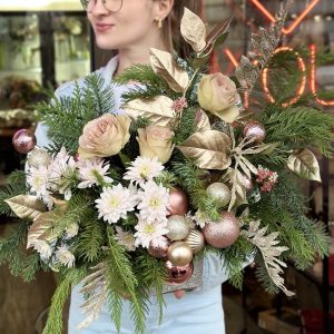 Christmas composition featuring roses, chrysanthemums, and sparkling ornaments, creating a festive and elegant holiday display.