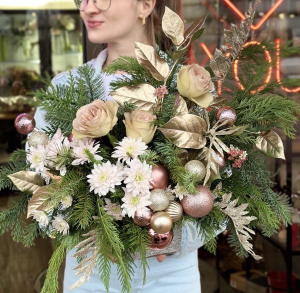 Christmas composition featuring roses, chrysanthemums, and sparkling ornaments, creating a festive and elegant holiday display.