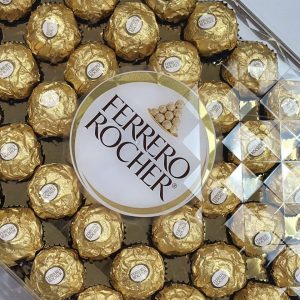 Ferrero Rocher chocolates featuring a hazelnut center coated in chocolate and crunchy hazelnut pieces, elegantly wrapped for gifting.