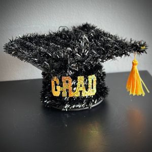Mini charming graduation cap with tassel, used as a decorative bouquet add-on for graduation gifts.