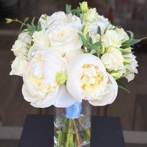 Bridal bouquet with soft spray roses, lush peonies, and fresh greenery