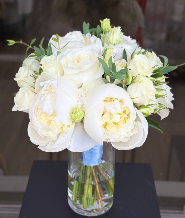 Bridal bouquet with soft spray roses, lush peonies, and fresh greenery