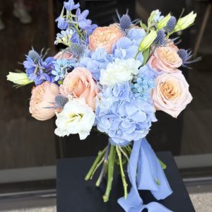 Wedding bouquet Edmonton – blue hydrangea and peach rose bridal flowers