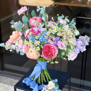 Wedding bouquet with ranunculus, roses, lisianthus & blue tweedia with boutonniere – Florans Edmonton