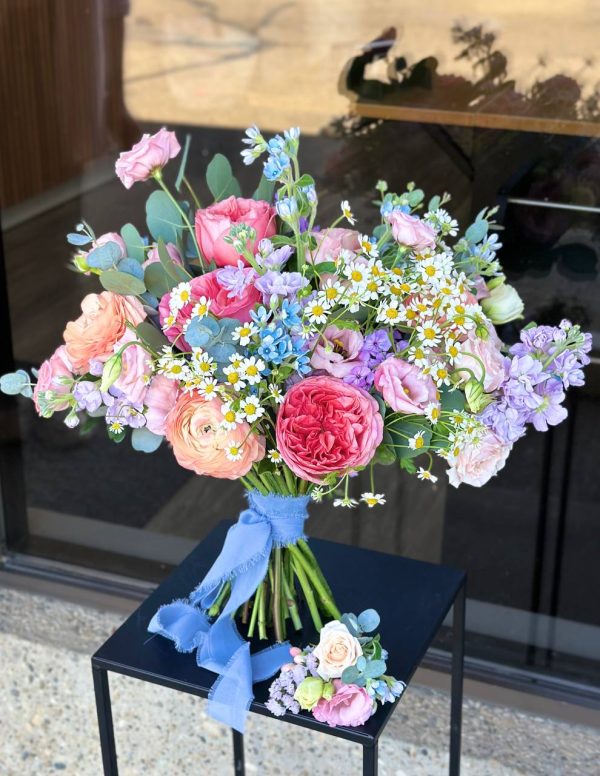 Wedding bouquet with ranunculus, roses, lisianthus & blue tweedia with boutonniere – Florans Edmonton
